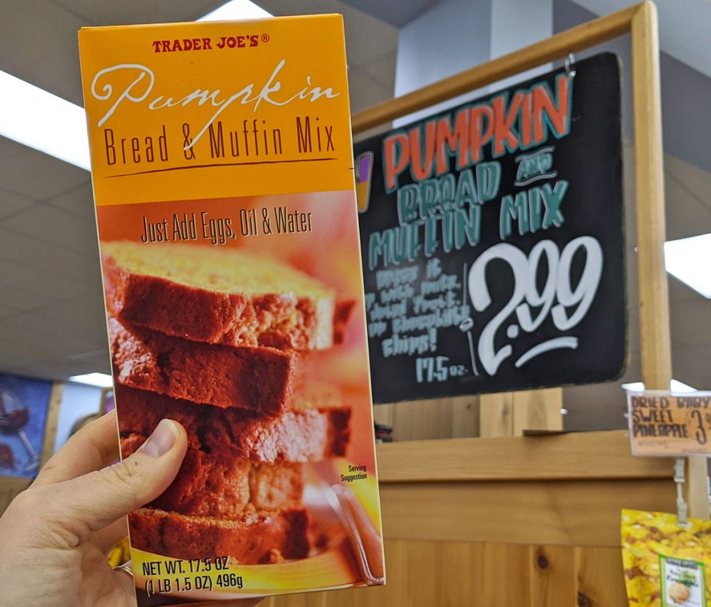 person holding up an orange box of pumpkin bread and muffin mix