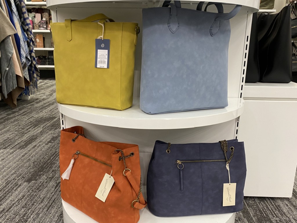 four handbags on display in store