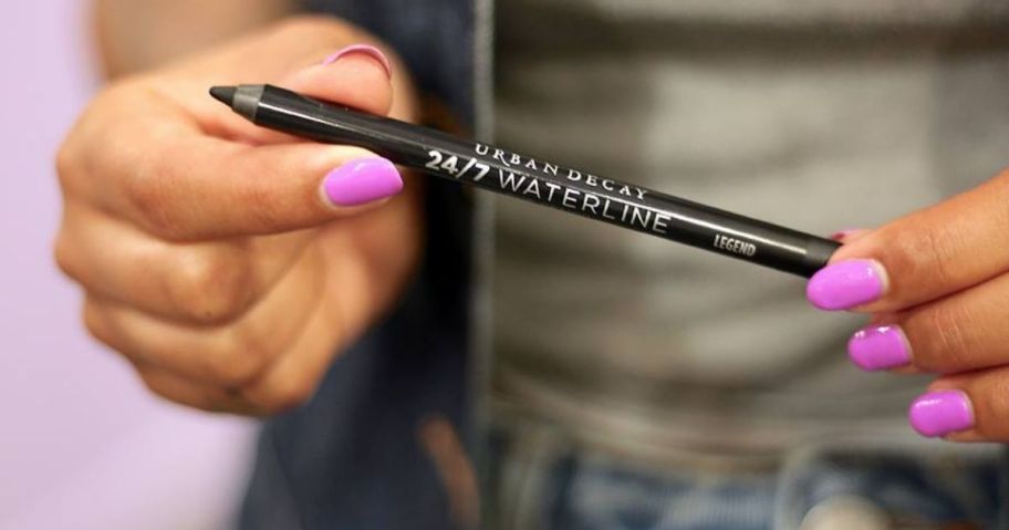 hand holding urban decay eye pencil