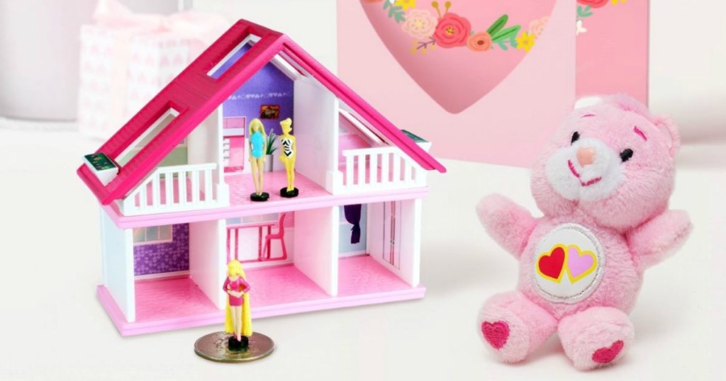 worlds smallest barbie house with a care bear next to it