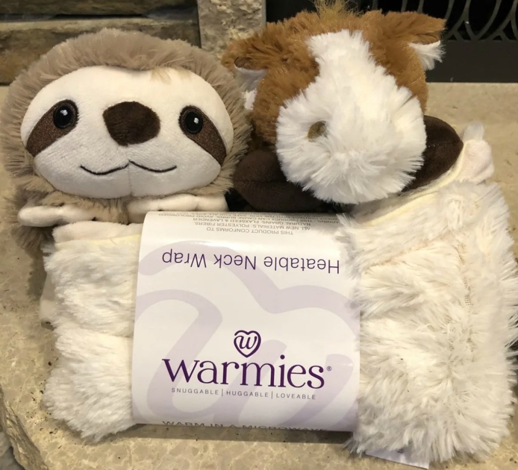 Two Warmies plush wraps on counter top - sloth and horse