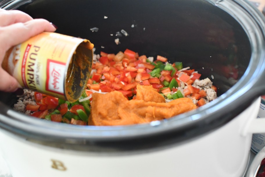 adding pumpkin to a slow cooker