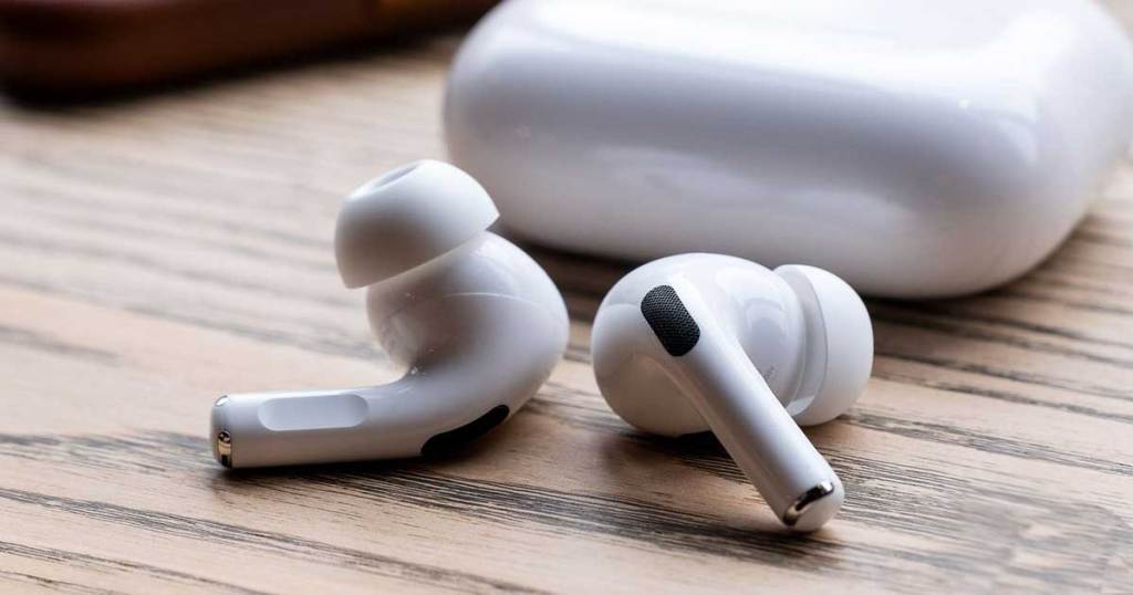 airpods on a table with a charging case