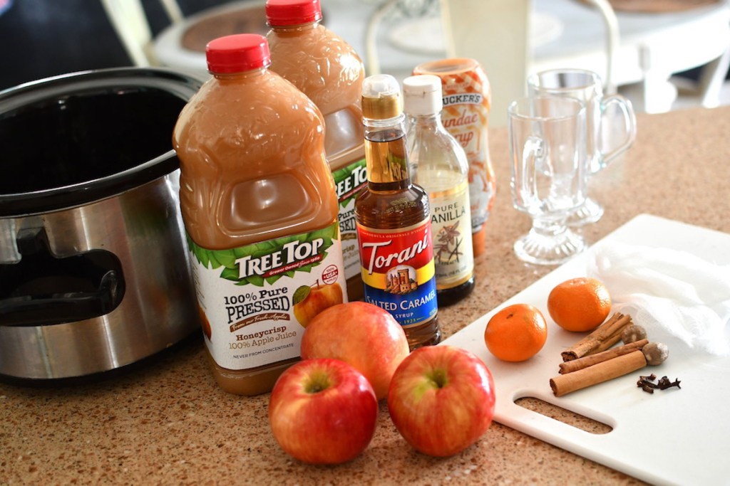 apple cider ingredients sitting next to crockpot on counter