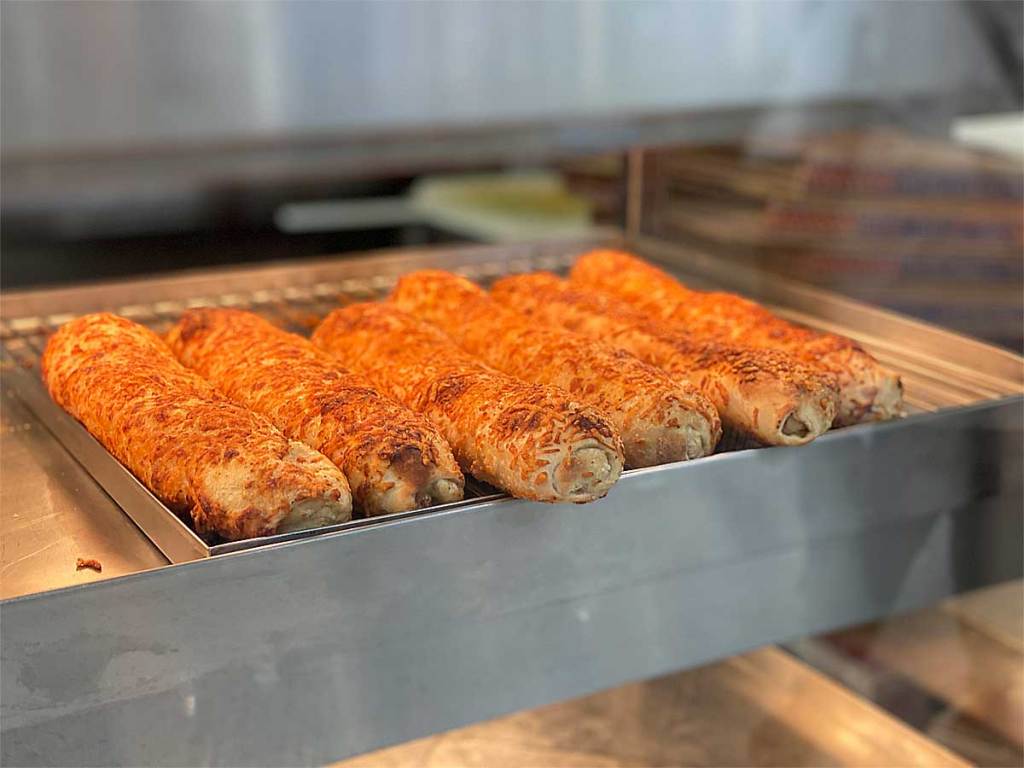 Chicken bake loafs in row in a warmer in-store