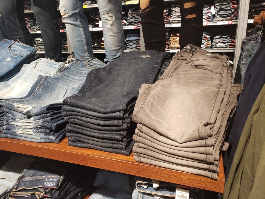 hollister guys jeans folded on shelf
