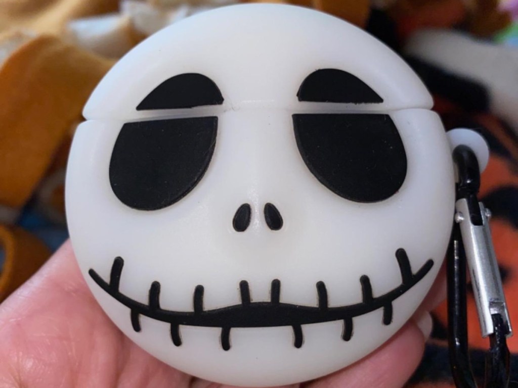 holding AirPods case shaped like Jack Skellington