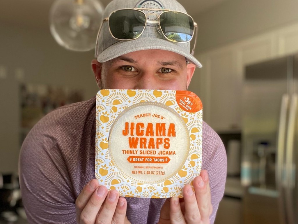 man holding package of jicama wraps