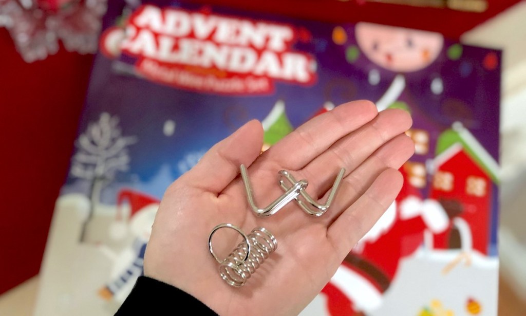 hand holding advent calendar metal puzzles