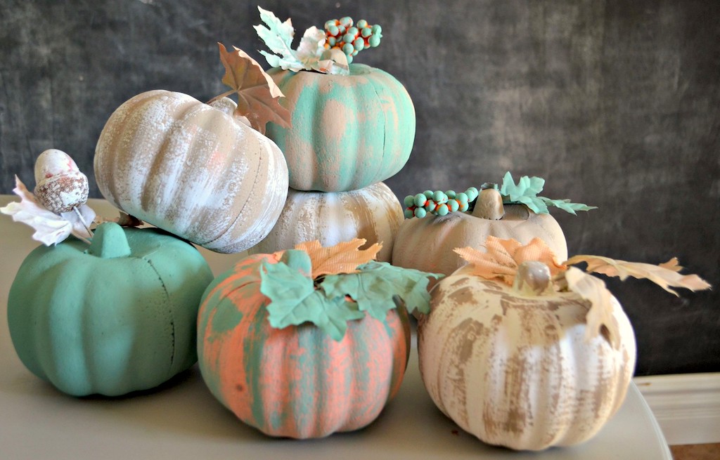 painted pumpkins stacked on top of each other 