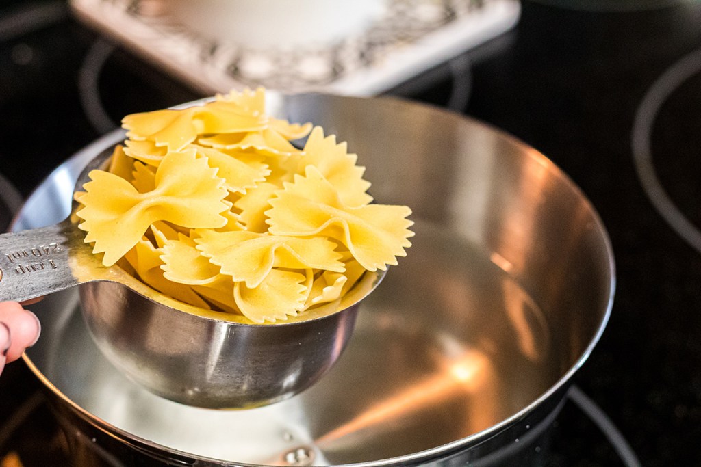 measuring cup of pasta noodles