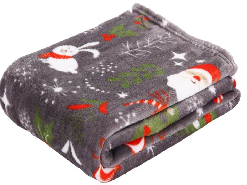 blanket that looks soft with Santa on it, folded neatly