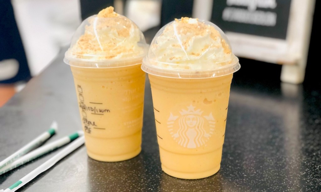 two starbucks pumpkin cheesecake frappuccinos sitting on counter