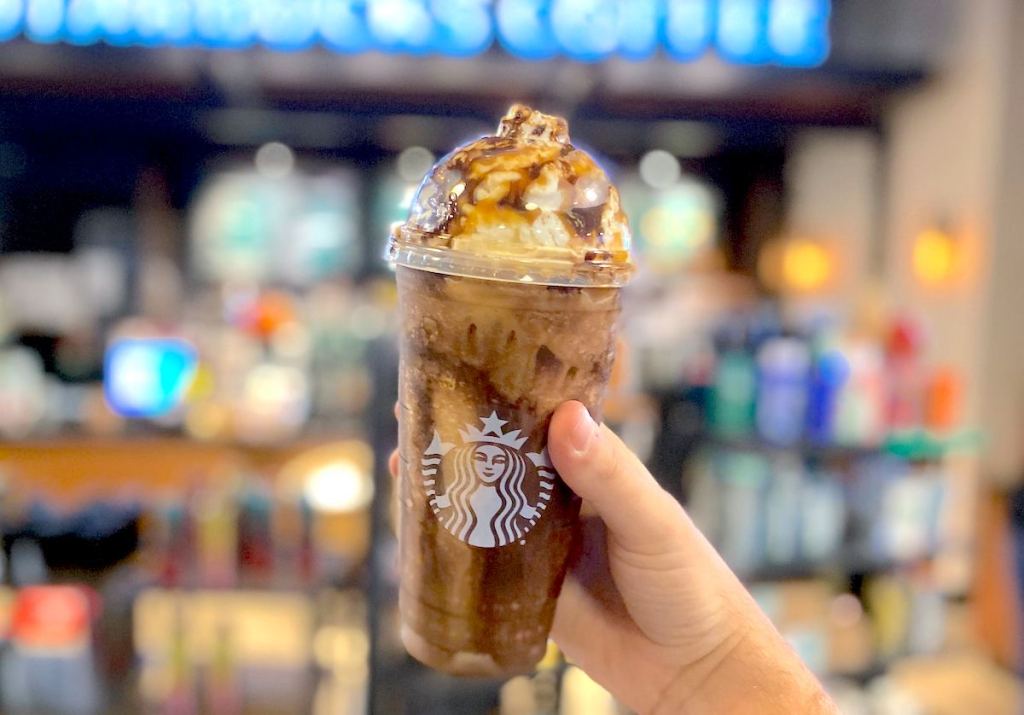 hand holding a chocolate pumpkin frappuccino