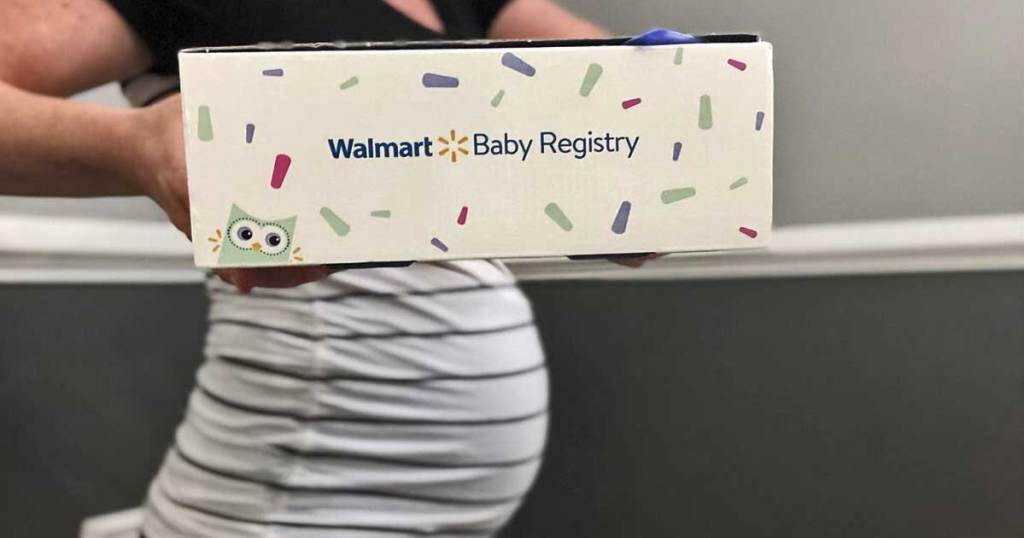 pregnant woman with baby bump holding a baby box