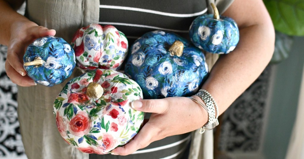 woman holding dollar tree pumpkins