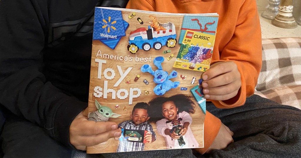 two boys holding the walmart 202 toy catalog