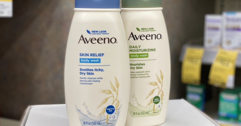 two aveeno body wash sitting next to each other on a shelf at walgreens