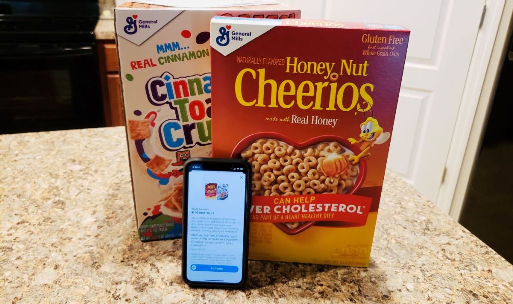 phone leaning against a box of Cheerios