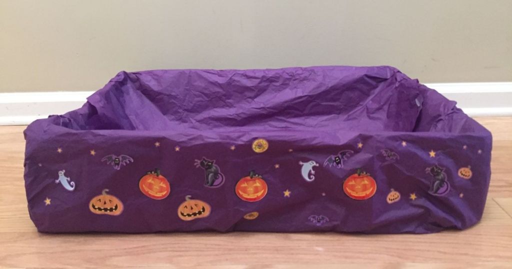 box covered with purple tissue paper and Halloween stickers