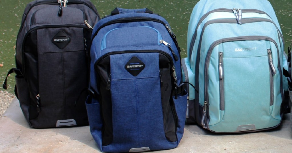 black backpack, navy backpack, and light blue backpack outside