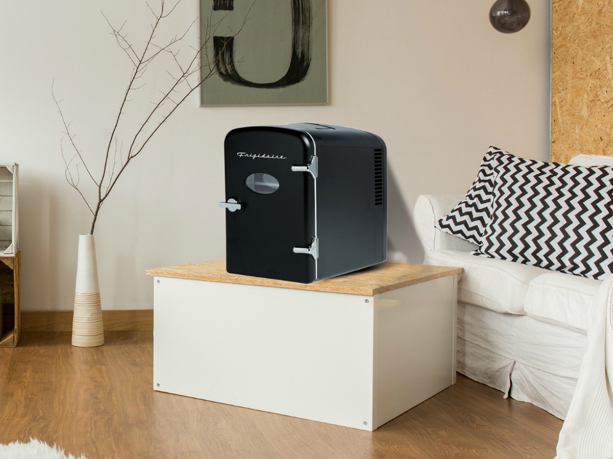 Small black fridge on a small end table