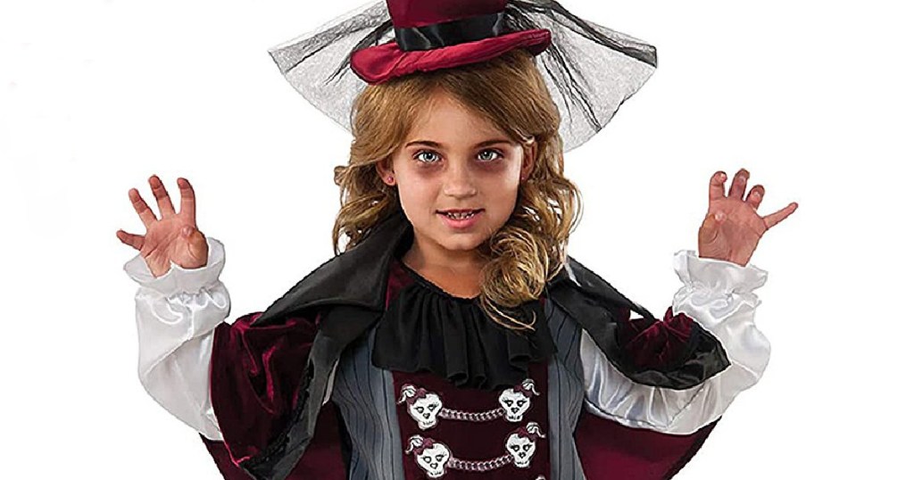 Little girls wearing scary makeup and a fancy vampire halloween costume