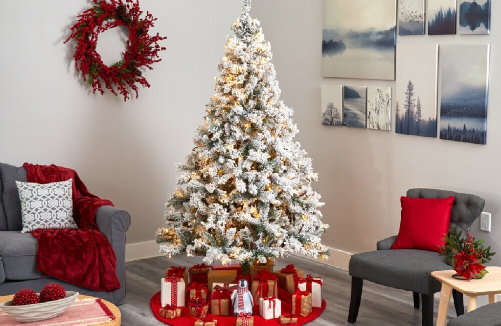 prelit large whte christmas tree in a living room