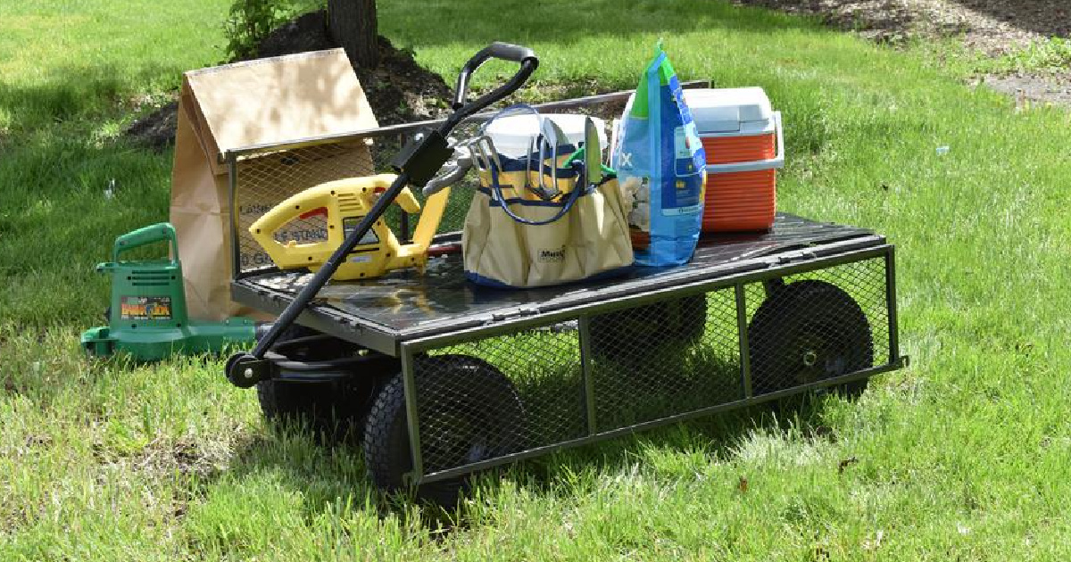 utility cart with cooler, mulch, and more in grass