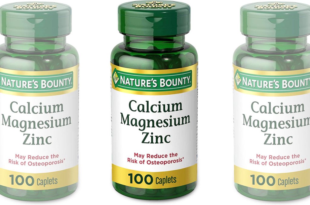 three green bottles of Nature's Bounty calcium magnesium & zinc supplement