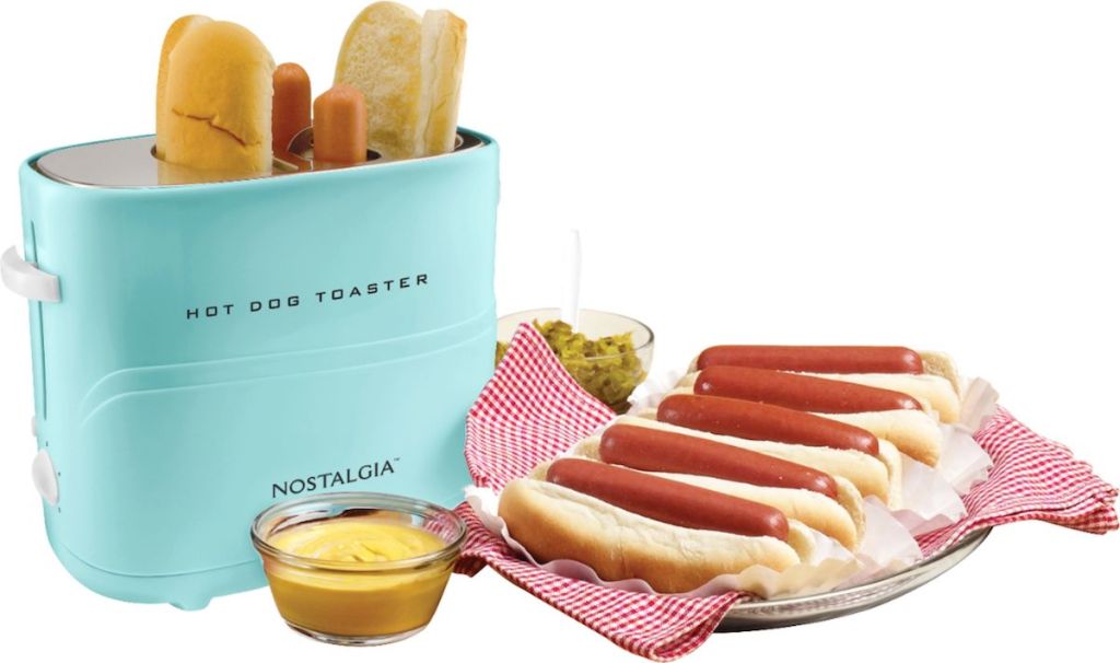 Nostalgia Hot Dog toaster next to plate of hot dogs