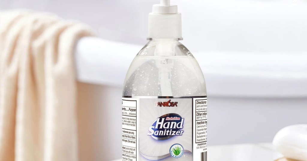bottle of hand sanitizer with soap and towel in background