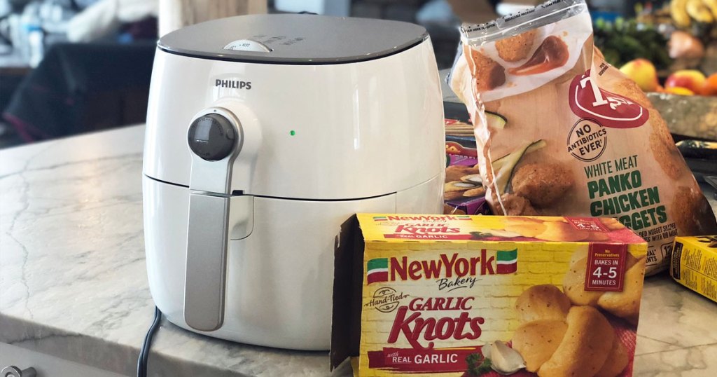 white Phillips air fryer on kitchen counter next to box of frozen garlic knots and chicken nuggets