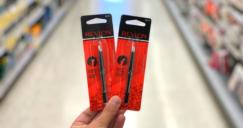 hand holding 2 Revlon Slanted Tweezers