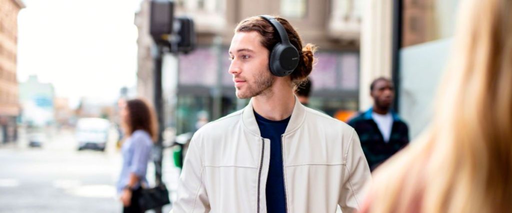 man walking on the street with headphones on