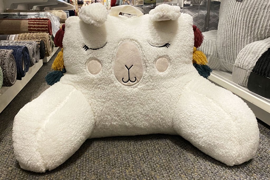 white llama shaped backrest pillow sitting on floor at kohl's