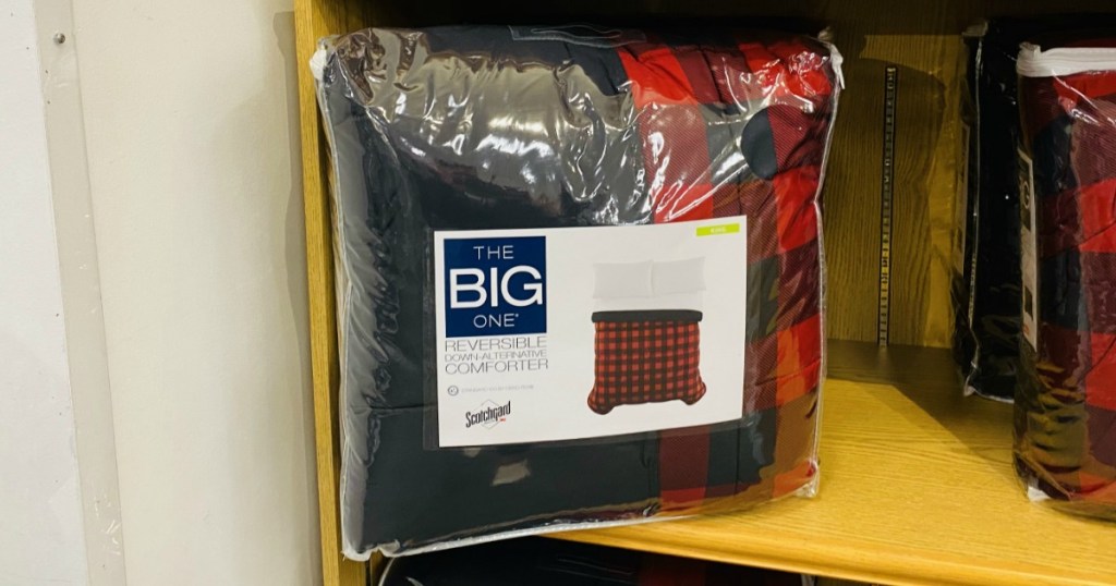 Large red and black plaid comforter set on a shelf in-store