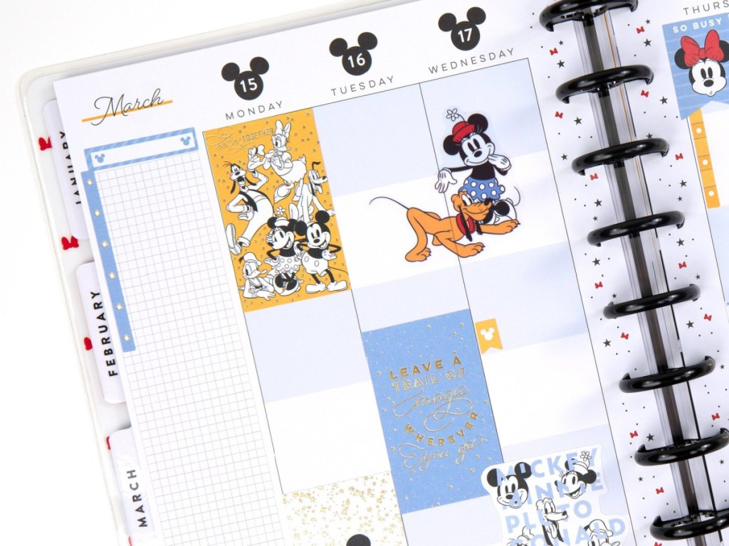 The happy Planner Disney Planner open with disney stickers on the pages