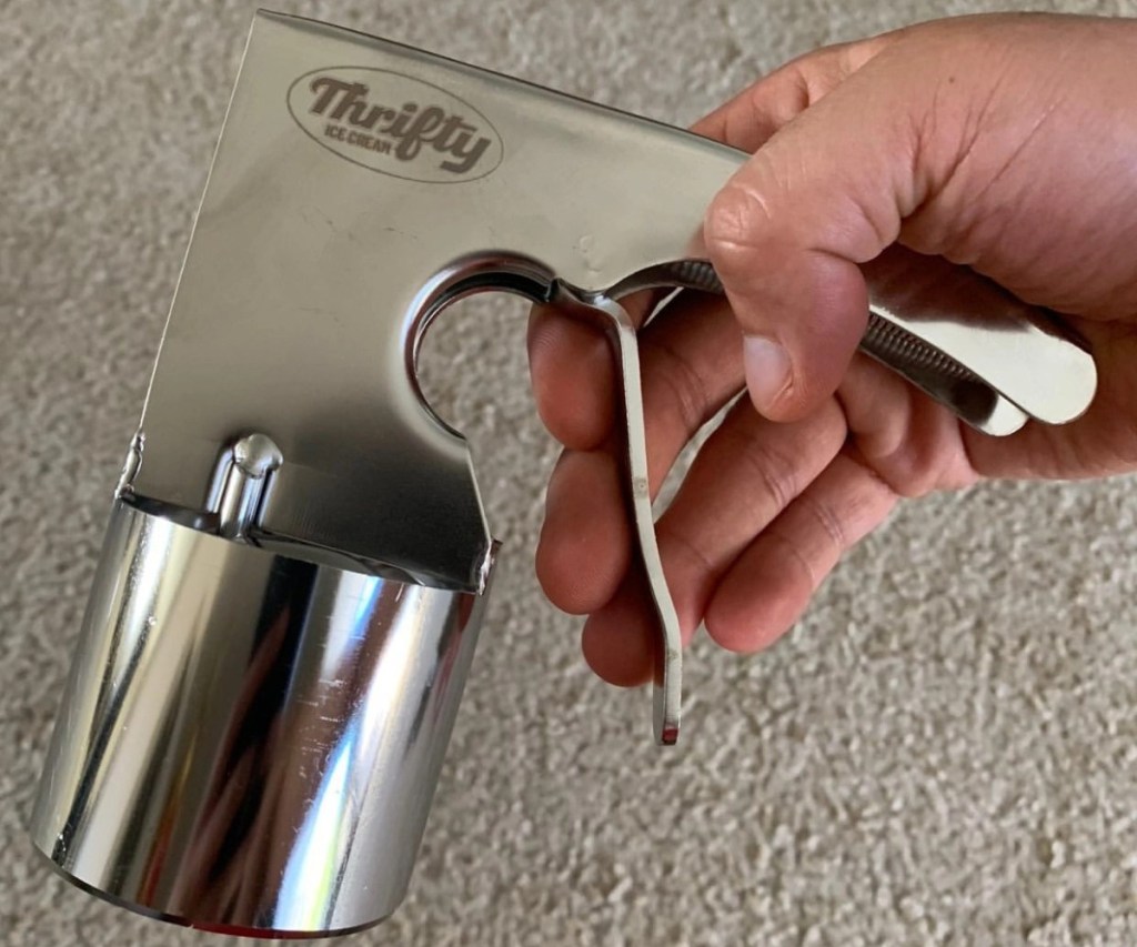 hand holding vintage ice cream scooper