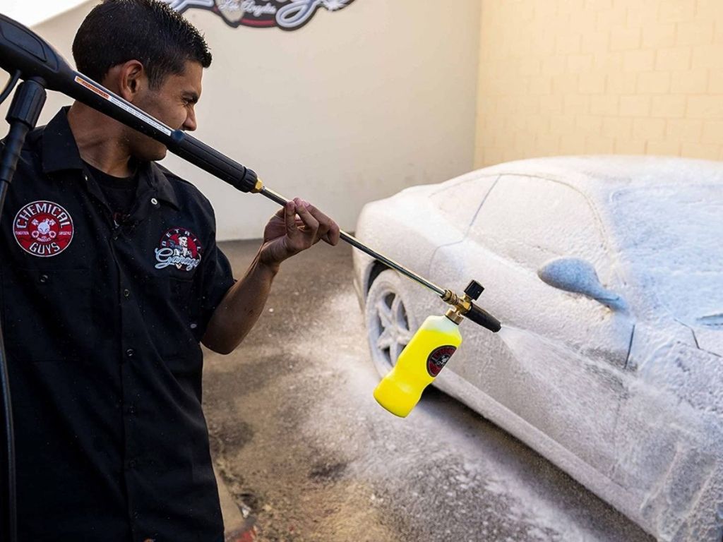 man washing car with car wash spray