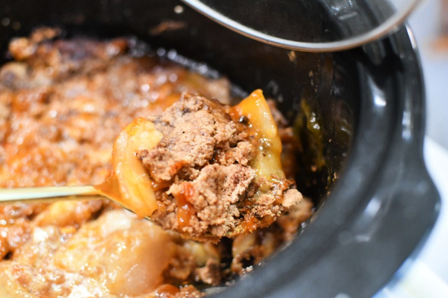 dishing up caramel apple dump cake from the crock-pot