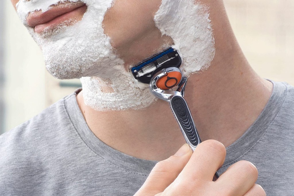 man shaving face using gillette proglide razor