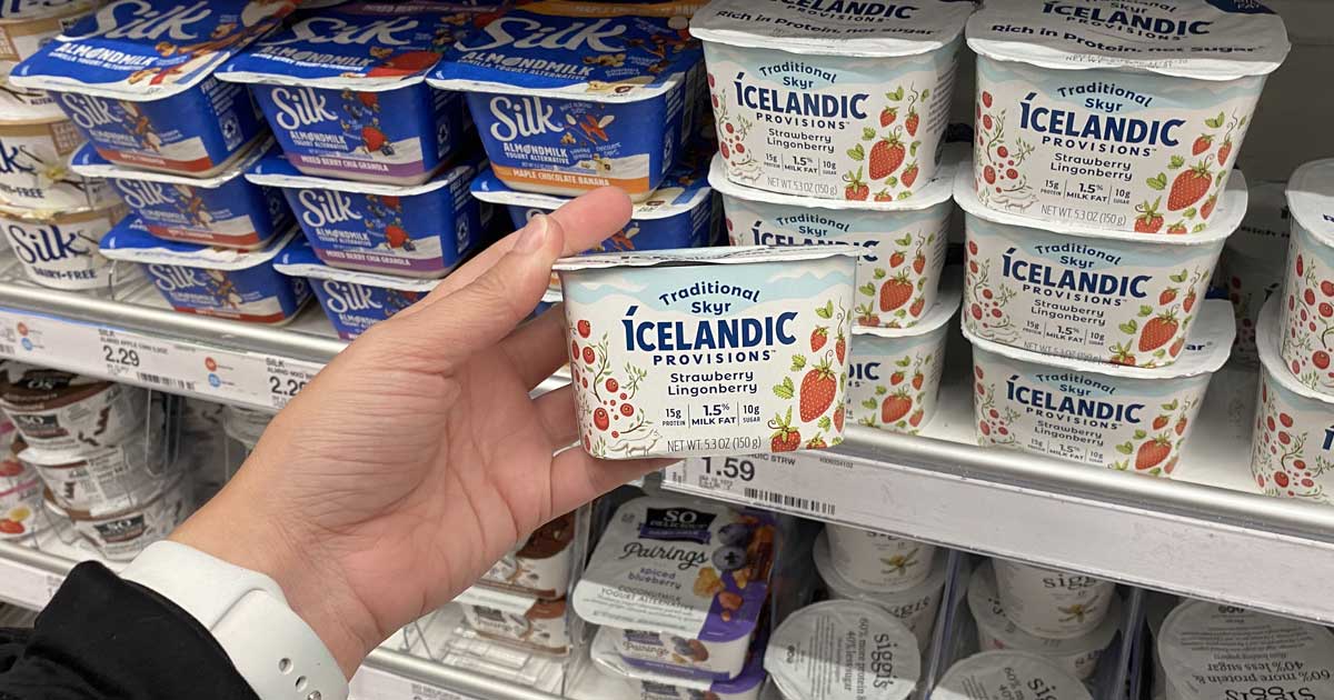 hand removing a cup of icelandic yogurt from a target store shelf