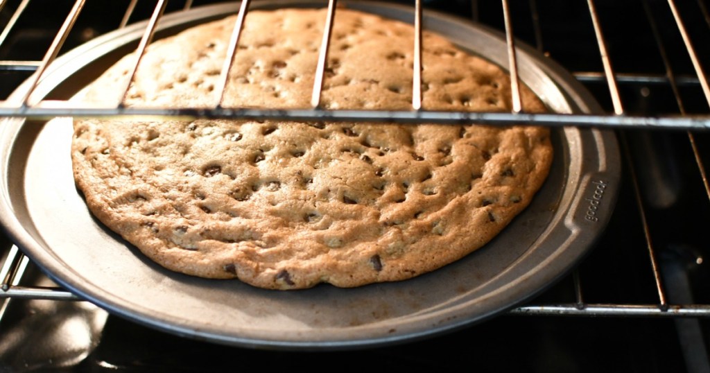 large cookie on a pizza pan cooking