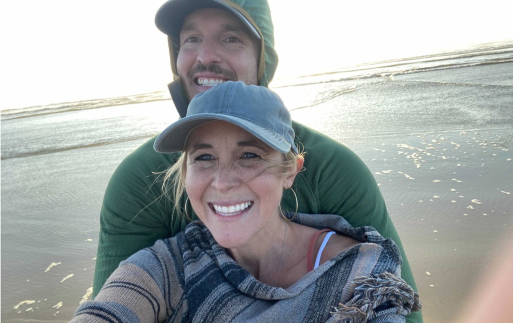 man and woman smiling on beach