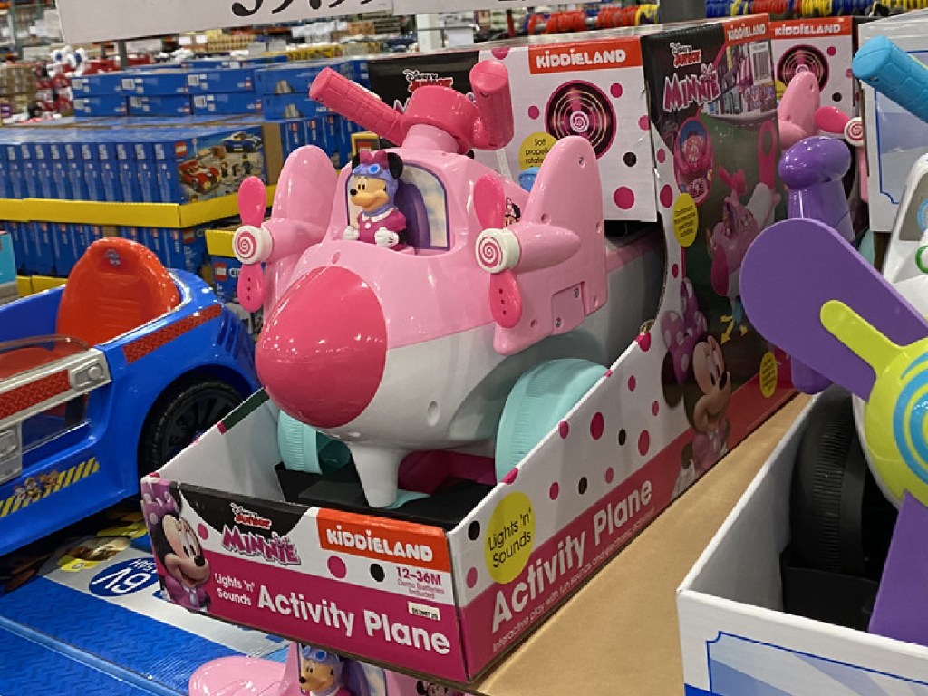 pink little toy plane in store with Minnie Mouse toy on it