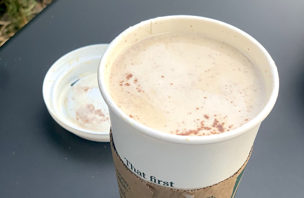 snickerdoodle latte in a starbucks cup with lid off