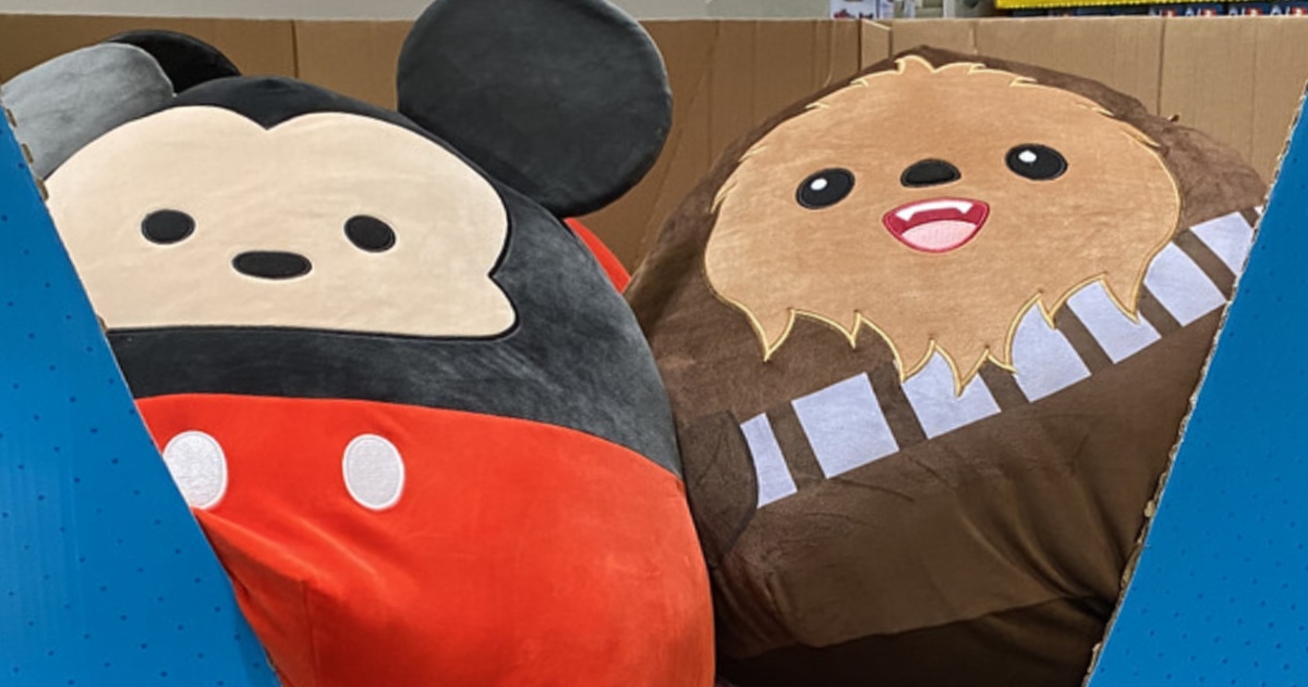 Two squishmallows in a blue box bin in store. One is a Disney Mikey and the other is a Star Wars Chewbacca