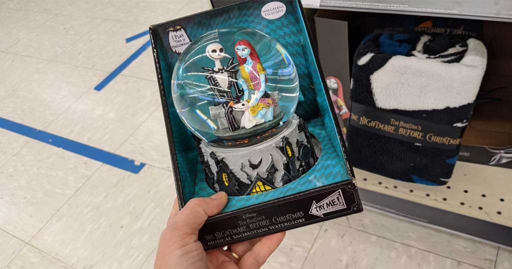 Hand holding a Disney Nightmare Before Christmas near in-store display