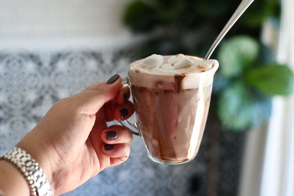 woman holding whipped hot chocolate 
